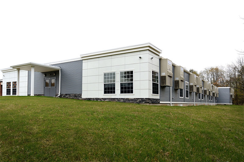 Innovative Modular Classroom building with a grassy hill in front, located in Pedricktown, NJ