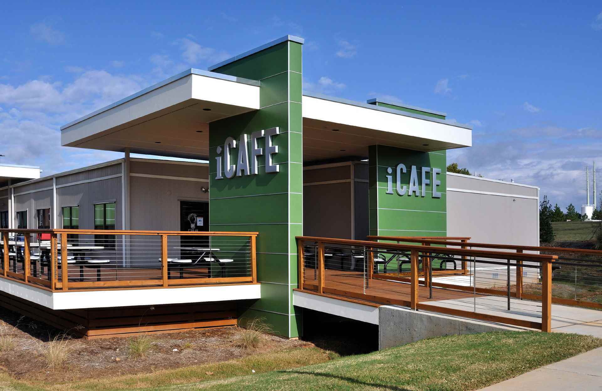 Green-roofed commercial building with a green sign located in Pedricktown, NJ