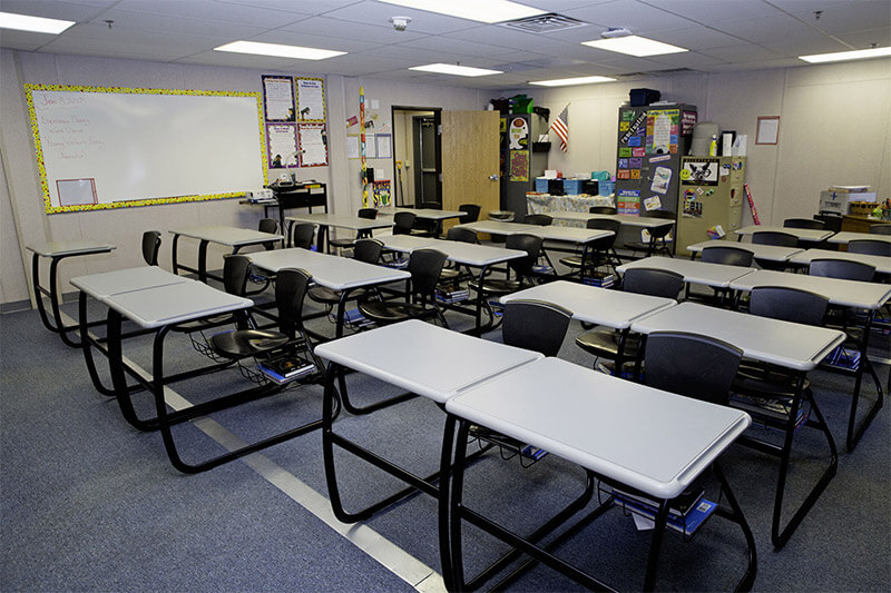 Organized modular classroom by Mobilease Modular Space with desks, chairs & storage cabinets