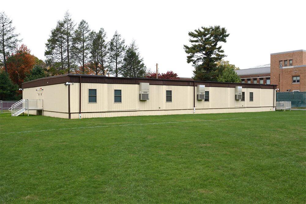 Flexspace modular classroom by Mobilease Modular Space, building on grassy school grounds