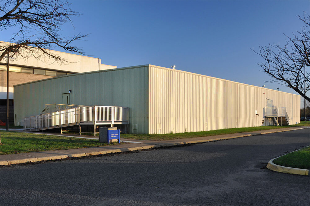 large beige flexspace modular metal building with ramps by Mobilease Modular Space