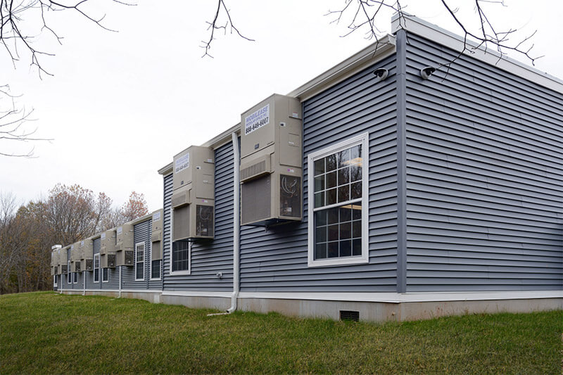 blue-modular-classroom Blue modular classroom by Mobilease Modular Space with windows and wall-mounted HVAC units
